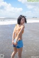 A woman in a bikini standing in the water.