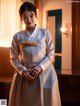 A woman in a white and gold hanbok standing in a room.